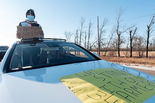 JESSE BOILY  / WINNIPEG FREE PRESS
Pritpal Singh stands through the sun roof of a car to show their support at the Kissan Rally in support of farmers on Sunday.   Sunday, Dec. 6, 2020.
Reporter: Ryan Thorpe
