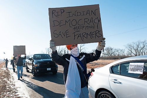 JESSE BOILY  / WINNIPEG FREE PRESS
A demonstrator walks past some cars while chanting support for the Kissan Rally in support of farmers on Sunday. Cars lined Mollard rd, and Pipeline Rd and looped around on the Perimeter highway. Sunday, Dec. 6, 2020.
Reporter: Ryan Thorpe
