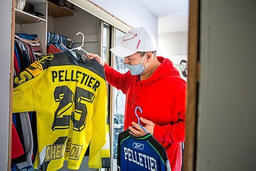 MIKAELA MACKENZIE / WINNIPEG FREE PRESS

Lloyd Pelletier pulls a couple of jerseys from the closet at his home in Lockport on Friday, Dec. 4, 2020. For Jeff Hamilton story.

Winnipeg Free Press 2020