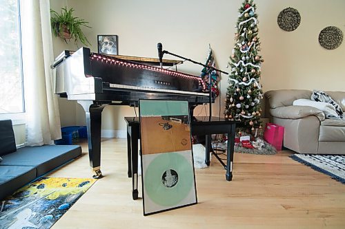 Mike Sudoma / Winnipeg Free Press
A record by the band Leaderhouse, a former band of Matts, sits in a  frame against a piano bench in Matts living room Sunday
December 7, 2020