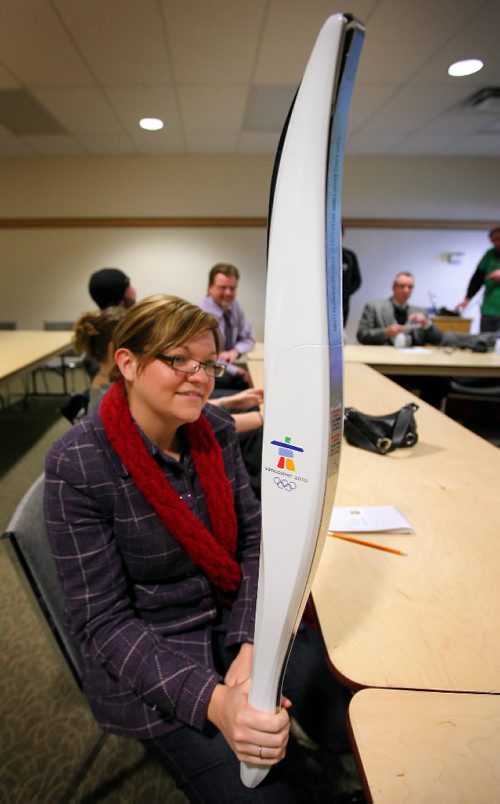 Brandon Sun Brandon Sun's Jillian Austin holds a replica Olympic torch during a media briefing held at the Discovery Centre on Wednesday. (Bruce Bumstead/Brandon Sun)