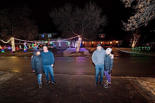 Mike Sudoma / Winnipeg Free Press
The Jasper family (Al and Dayle) (left) and the Paterson family (Paula and Jason) in front of their respective house on Shorecrest drive. The street has been a popular attraction amongst Winnipeggers looking for something to do as many of the residents of the neighbourhood have decorated their houses with dazzling light displays. 
December 3, 2020