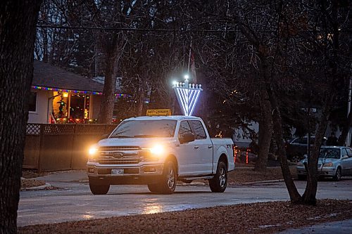 Mike Sudoma / Winnipeg Free Press
A truck mounted with a menorah drives down Mathers Avenue Thursday evening, sharing Chanukah cheer for everyone celebrating inside. The truck is stocked with menorahs and candles to hand out to those who dont have any to celebrate the Chanukah festival with.
December 9, 2020