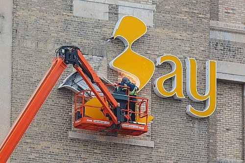 MIKE DEAL / WINNIPEG FREE PRESS
One of the signs that the Bay Downtown is gone is the removal of the logos adorning the building Friday morning.
201211 - Friday, December 11, 2020.