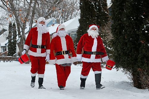 JOHN WOODS / WINNIPEG FREE PRESS
Michael Cheetham, from left, Jason Gray and Lee Jacobson dress as Santa and go around visiting children outside their homes Sunday, December 13, 2020. The friends are collecting food for Harvest Manitoba.

Reporter: Speirs