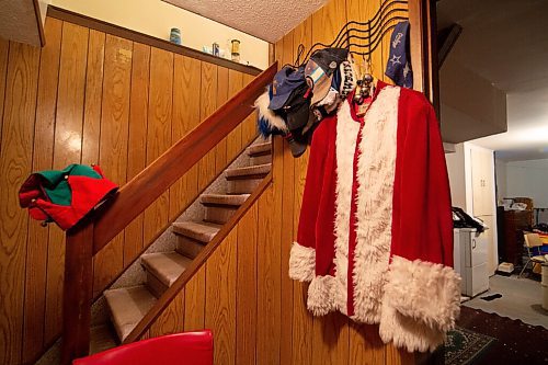 MIKE SUDOMA / WINNIPEG FREE PRESS
A Santa jacket hangs up amongst the baseball caps on a wall in the basement of Stan Bedernjaks home Sunday evening.
December 13, 2020