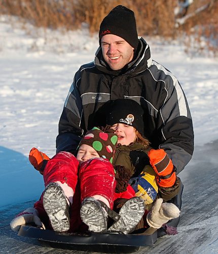 BORIS.MINKEVICH@FREEPRESS.MB.CA BORIS MINKEVICH/ WINNIPEG FREE PRESS  100110 Brad Alsip with his son Kaden,4, and daughter Maddie,6.(daughter Maddie is in front in Red.) They were sliding on the big toboggan slide at Fort Whyte Alive.