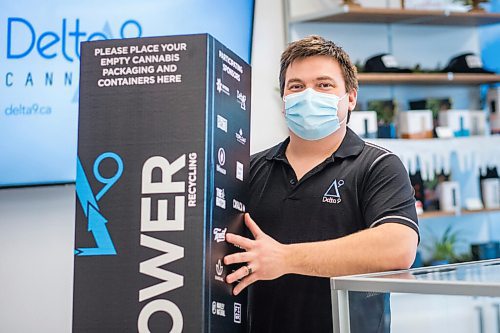 MIKAELA MACKENZIE / WINNIPEG FREE PRESS

Trevor Duncan, Kenaston Delta 9 Cannabis store manager, poses for a portrait with new recycling boxes for cannabis packaging and vape pen cartridges in Winnipeg on Wednesday, Dec. 16, 2020. For Nicole Brownlee story.

Winnipeg Free Press 2020