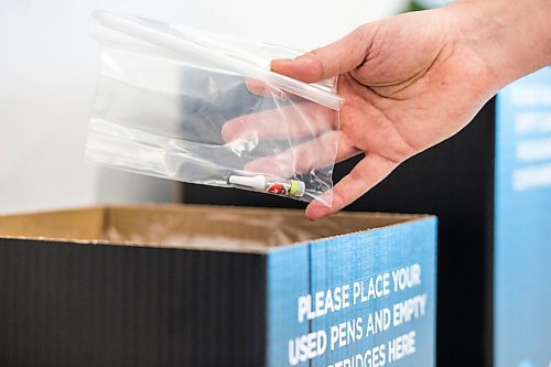 MIKAELA MACKENZIE / WINNIPEG FREE PRESS

Trevor Duncan holds an example of a recyclable vape pen cartridge over new recycling boxes for cannabis packaging and vape pen cartridges at the Kenaston Delta 9 Cannabis store in Winnipeg on Wednesday, Dec. 16, 2020. For Nicole Brownlee story.

Winnipeg Free Press 2020