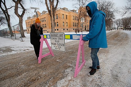 JOHN WOODS / WINNIPEG FREE PRESS
Isaac Brock grade 9 students Emma and Dakota put out barricades to stop traffic on Barratt in Winnipeg Wednesday, December 16, 2020. At the start of the school year Winnipeg School Division, the Green Action Centre and the City of Winnipeg partnered to launch the inaugural Safe Streets project in Winnipeg

Reporter: MacIntosh