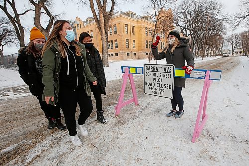 JOHN WOODS / WINNIPEG FREE PRESS
Isaac Brock grade 9 students put out barricades to stop traffic on Barratt and say good bye to principle Marla Tran in Winnipeg Wednesday, December 16, 2020. At the start of the school year Winnipeg School Division, the Green Action Centre and the City of Winnipeg partnered to launch the inaugural Safe Streets project in Winnipeg

Reporter: MacIntosh