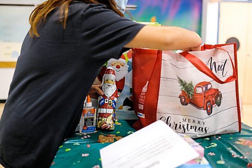 Daniel Crump / Winnipeg Free Press. A child at Rossbrook House goes through their gift bag. Because of the pandemic and shopping restrictions each gift bag contains creative DIY crafts that use essential items still being sold in stores. December 16, 2020.