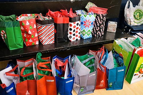 Daniel Crump / Winnipeg Free Press. Christmas gifts are lined up for participants at the Rossbrook House childcare programs. Because of the pandemic and shopping restrictions each gift bag contains creative DIY crafts that use essential items still being sold in stores. December 16, 2020.