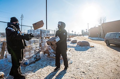 MIKAELA MACKENZIE / WINNIPEG FREE PRESS

Curtis Garson (left) throws a box of fish to Richard Dumas as they load up boxes of pickerel into peoples' cars, as the fish couldn't be sold internationally this year, at the Canad Inns in Winnipeg on Thursday, Dec. 17, 2020. For Cody Sellar story.

Winnipeg Free Press 2020