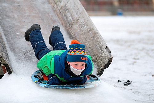 Daniel Crump / Winnipeg Free Press. Grayson Wiebe, 7, takes a ride on the toboggan slide at Roblin Park Community Centre in Charleswood. December 19, 2020.