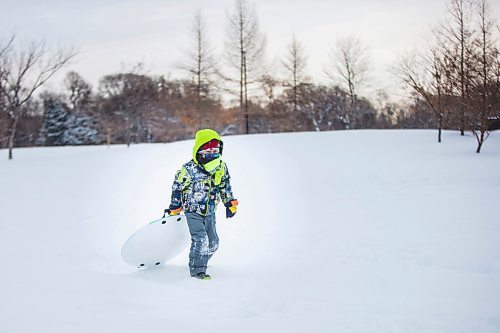 MIKAELA MACKENZIE / WINNIPEG FREE PRESS

River Wesley, six, heads back up the toboggan hill for another run at Assiniboine Park in Winnipeg on Monday, Dec. 21, 2020.  Standup.

Winnipeg Free Press 2020