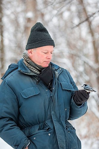 MIKAELA MACKENZIE / WINNIPEG FREE PRESS

Allan Robertson feeds the birds sunflower seeds after a fresh snowfall at Assiniboine Park in Winnipeg on Monday, Dec. 21, 2020.  He's come to the park to feed the nuthatches and chickadees for six years. Standup.

Winnipeg Free Press 2020