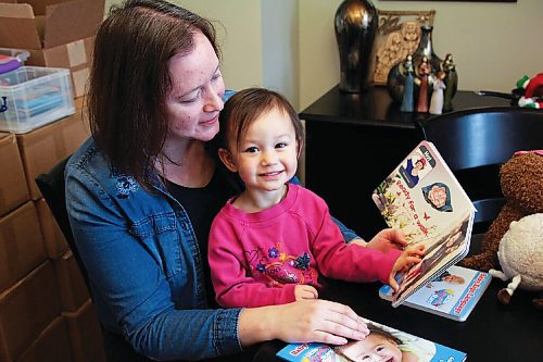 Canstar Community News Serena Yong and her daughter Jazlyn flip through a copy of Yongs latest book, Baby Sign Language Touch Feel Learn.