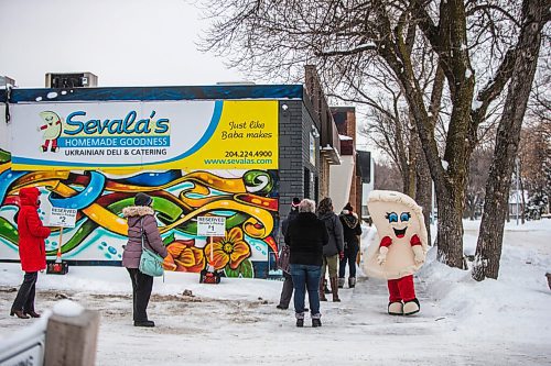 MIKAELA MACKENZIE / WINNIPEG FREE PRESS

Their perogie mascot entertains a line up of folks outside of Sevala's Ukrainian Deli at opening time in Winnipeg on Tuesday, Dec. 22, 2020. For Dave Sanderson story.

Winnipeg Free Press 2020