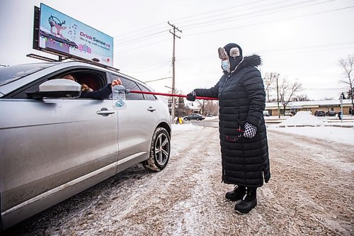 MIKAELA MACKENZIE / WINNIPEG FREE PRESS

Rosi Napady accepts a donation at a drive-in kettle fundraiser, the product of a collaboration between the Legion and the Salvation Army, takes place at the Charleswood Legion in Winnipeg on Tuesday, Dec. 22, 2020. 

Winnipeg Free Press 2020