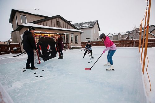 JOHN WOODS / WINNIPEG FREE PRESS
Espen and Nichole Elvebo and their children Felix and Anne enjoy their outdoor rink in Winnipeg Tuesday, December 22, 2020. The couple has taken advantage of the schools k-8 remote learning opt-in option due to COVID-19. 

Reporter: MacIntosh
