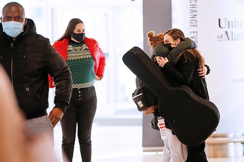 JOHN WOODS / WINNIPEG FREE PRESS
As Marilynn Champagne, left, looks on Madelaine Champagne, right, is happy to see Kyra Mastro who arrives at the airport to visit her in Winnipeg Wednesday, December 23, 2020.  

Reporter: Abas