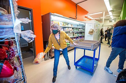 MIKAELA MACKENZIE / WINNIPEG FREE PRESS

Volunteer Kathy Turenne prepares for opening by stocking the bread shelf at the Essentials Market at the Main Street Project in Winnipeg on Thursday, Dec. 24, 2020. For --- story.

Winnipeg Free Press 2020