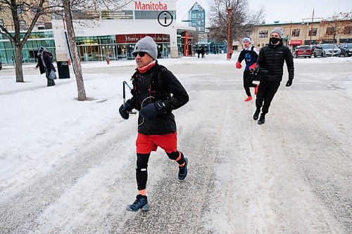 Daniel Crump / Winnipeg Free Press. Junel Malapad rounds the last corner of another lap into the Inn at The Forks, which is the start and end point for each lap. Today is his final day of Malapads marathon of marathons and he is running 100km, double the distance. December 26, 2020.