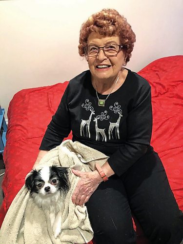 Canstar Community News Freda Glow shows off Chester, the Japanese Chin who runs the household of her oldest son.