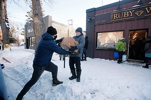 JOHN WOODS / WINNIPEG FREE PRESS
Melissa Bowman Wilson hands a box of food to David Boning to pack into his van outside The Ruby West restaurant on Westminster to deliver to the Bear Clan Monday, December 28, 2020. A group of Wolseley residents gathered food for the Bear Clan.

Reporter: Rutgers