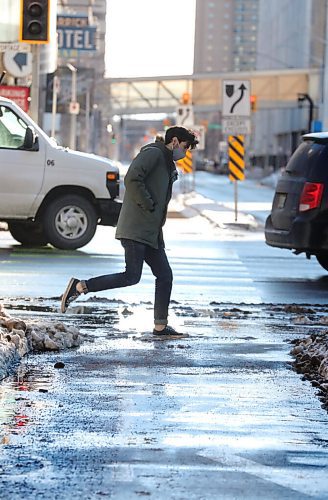 RUTH BONNEVILLE / WINNIPEG FREE PRESS

Local - Street work

Pedestrians make their way over wet and messy streets along Portage Ave. Monday.

For story on wet, messy streets with snow banks.

Jan 04,. 2021