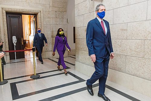 MIKE DEAL / WINNIPEG FREE PRESS
New cabinet ministers Audrey Gordon, Minister of Mental Health, Wellness and Recovery, and Derek Johnson, Minister of Municipal Relations, follow Premier Brian Pallister after being sworn in Tuesday morning.
210105 - Tuesday, January 05, 2021.