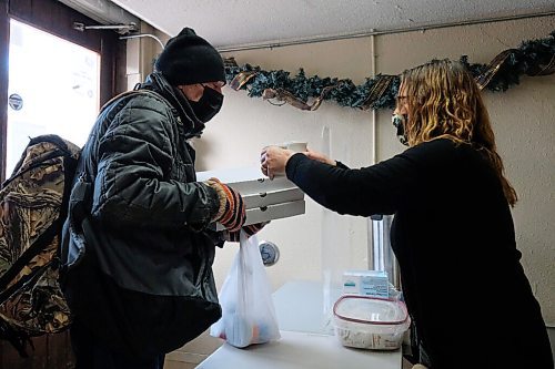 Daniel Crump / Winnipeg Free Press. A person picks up pizzas and coffee at 1JustCity's West End Site St Matthews Maryland Community Ministry Saturday afternoon. The program is opening its doors on the weekend for the first time in its 40 year history of serving the community. January 9, 2020.