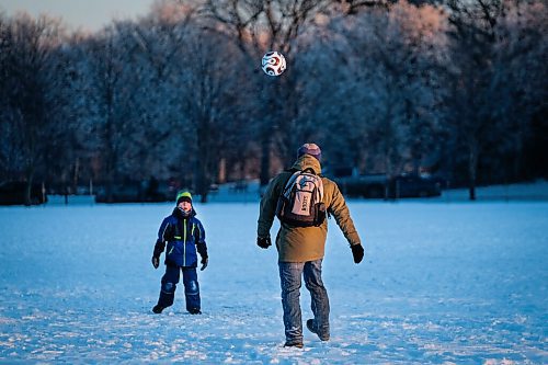Daniel Crump / Winnipeg Free Press. Two people kick a soccer ball around on a snow covered field in Assiniboine Park on Saturday afternoon. January 9, 2020.