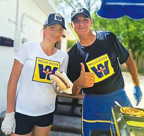 Canstar Community News Will Gault and wife Courtney are pictured selling food from their Willy Dogs cart in warmer times. Now offering curbside pickup at Deer Lodge Curling Club, the business is making donations to 210 Recovery with every Soko burger or hotdog it sells.
