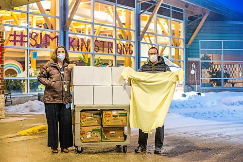 MIKAELA MACKENZIE / WINNIPEG FREE PRESS

Cindy Greenlay, manager of support services (left), and Ian Kleinsasser, member of Crystal Springs Hutterite Colony, pose with boxes of isolation gowns at the Simkin Centre in Winnipeg on Thursday, Jan. 14, 2021.  Hutterite colonies sewed the isolation gowns for the Jewish personal care home, repaying a kindness shows decades ago when Jewish business people stood up for Hutterites to buy land in Manitoba. For Brenda Suderman story.

Winnipeg Free Press 2021