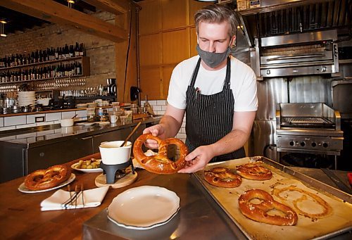 MIKE DEAL / WINNIPEG FREE PRESS
Andrew Koropatnick is the new head chef at Oxbow Restaurant (557 Osborne Street).
Andrew puts together an example of their new item, the Alpine Fondue Kit, which consists of a German pretzels, a three cheese fondue (Briere, Emnenthanl, and Raclatte) and some pickled sides.
See Eva Wasney story
210115 - Friday, January 15, 2021.