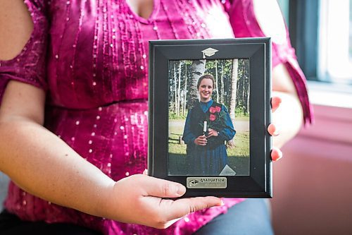 MIKAELA MACKENZIE / WINNIPEG FREE PRESS

Gloria Froese, former Church of God member, poses for a portrait with her graduation photo (from the time when she was with the church) at her home in Winnipeg on Friday, Jan. 15, 2021.  For Kevin story.

Winnipeg Free Press 2021