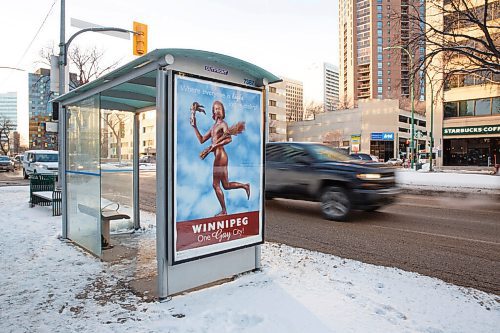 MIKE DEAL / WINNIPEG FREE PRESS
A bus shelter at Donald and Broadway with the One Gay City poster.
Lorri Millan and Shawna Dempsey set out more than two decades ago to depict Winnipeg as a safe haven for the LGBTQ community through a mock advertising campaign. It never saw the light of day then. 23 years later, their art work, posters heralding Winnipeg as "One Gay City", has been displayed on three bus shelters in the downtown, as part of a new art project from the University of Manitoba School of Art Gallery.
210115 - Friday, January 15, 2021.