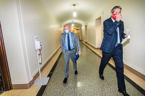 MIKAELA MACKENZIE / WINNIPEG FREE PRESS

Dr. Brent Roussin, chief provincial public health officer (left), and Premier Brian Pallister talk to each other in the hallway after a press conference at the Manitoba Legislative Building in Winnipeg on Friday, Jan. 15, 2021.  For Carol Sanders story.

Winnipeg Free Press 2021