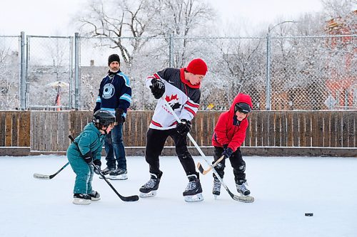 Daniel Crump / Winnipeg Free Press. Myles Raichura (middle) plays hockey with his family at the West Broadway Community Centre on Saturday morning. January 16, 2021.