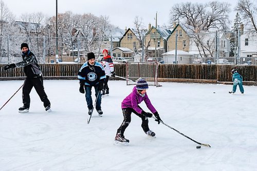 Daniel Crump / Winnipeg Free Press. Yafa Ennadzki (right) plays hockey with her family at the West Broadway Community Centre on Saturday morning. January 16, 2021.