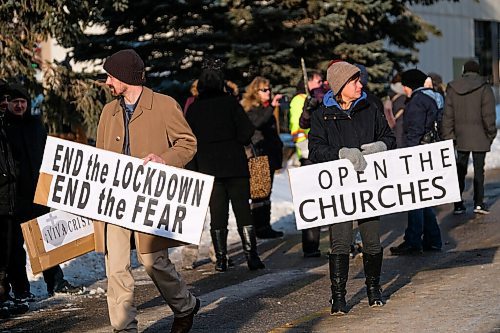 Daniel Crump / Winnipeg Free Press. People hold signs during an anti-mask protest organized by the group Hugs Over Masks outside city hall in Steinbach, Manitoba. January 16, 2020.