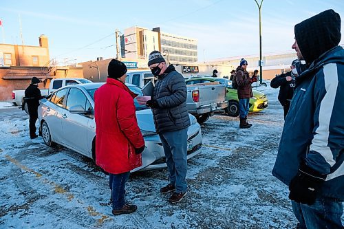 Daniel Crump / Winnipeg Free Press. RCMP issue a ticket to anti-mask activist Gerry Bohemier who spoke at the Hugs Over Masks protest in Steinbach. January 16, 2021.
