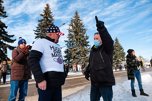 Daniel Crump / Winnipeg Free Press. A protestor (left) and counter protestor (right) debate during the Hugs Over Masks protest in Steinbach, Manitoba. January 16, 2021.