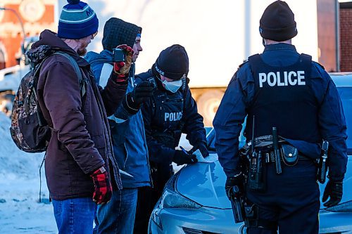 Daniel Crump / Winnipeg Free Press. RCMP issue a ticket to anti-mask activist Patrick Allard who spoke at the Hugs Over Masks protest in Steinbach. January 16, 2021.