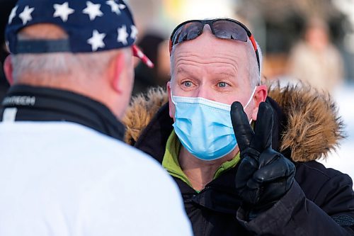 Daniel Crump / Winnipeg Free Press. A protestor (left) and counter protestor (right) debate during the Hugs Over Masks protest in Steinbach, Manitoba. January 16, 2021.