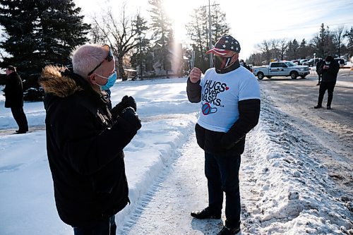 Daniel Crump / Winnipeg Free Press. A protestor (right) and counter protestor (left) debate during the Hugs Over Masks protest in Steinbach, Manitoba. January 16, 2021.