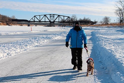 Canstar Community News Gilles Chabot and his dog Daisy trek the walking path on the Assiniboine River on Jan. 13. The path runs parallel to the skating trail. (GABRIELLE PICHÉ/CANSTAR COMMUNITY NEWS/HEADLINER)