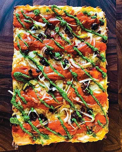 Canstar Community News One Great City Brewing Co.'s entry in Le Vegan Week is this Detroit style pizza, featuring marinated sundried tomatoes, artichoke hearts, basil almond pesto, marinara, pickled fennel, Daiya cheese.
